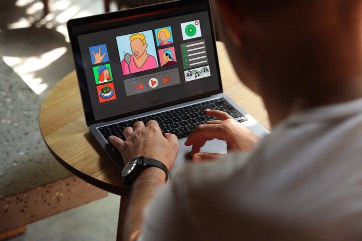 Man using laptop with music streaming